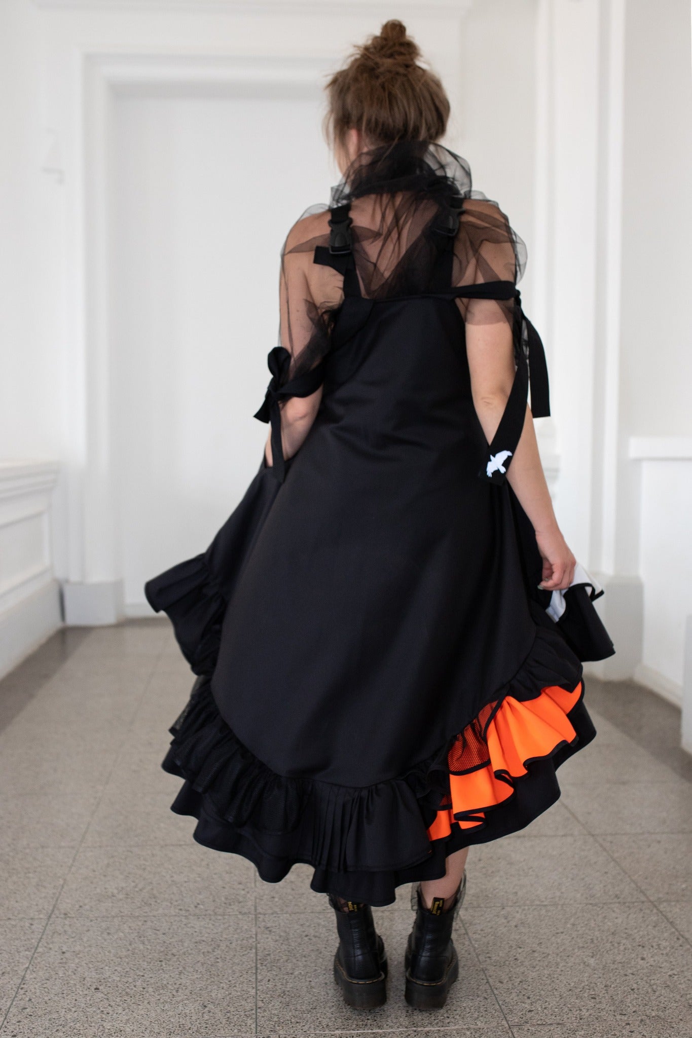 Black fronzi dress with orange details and frills