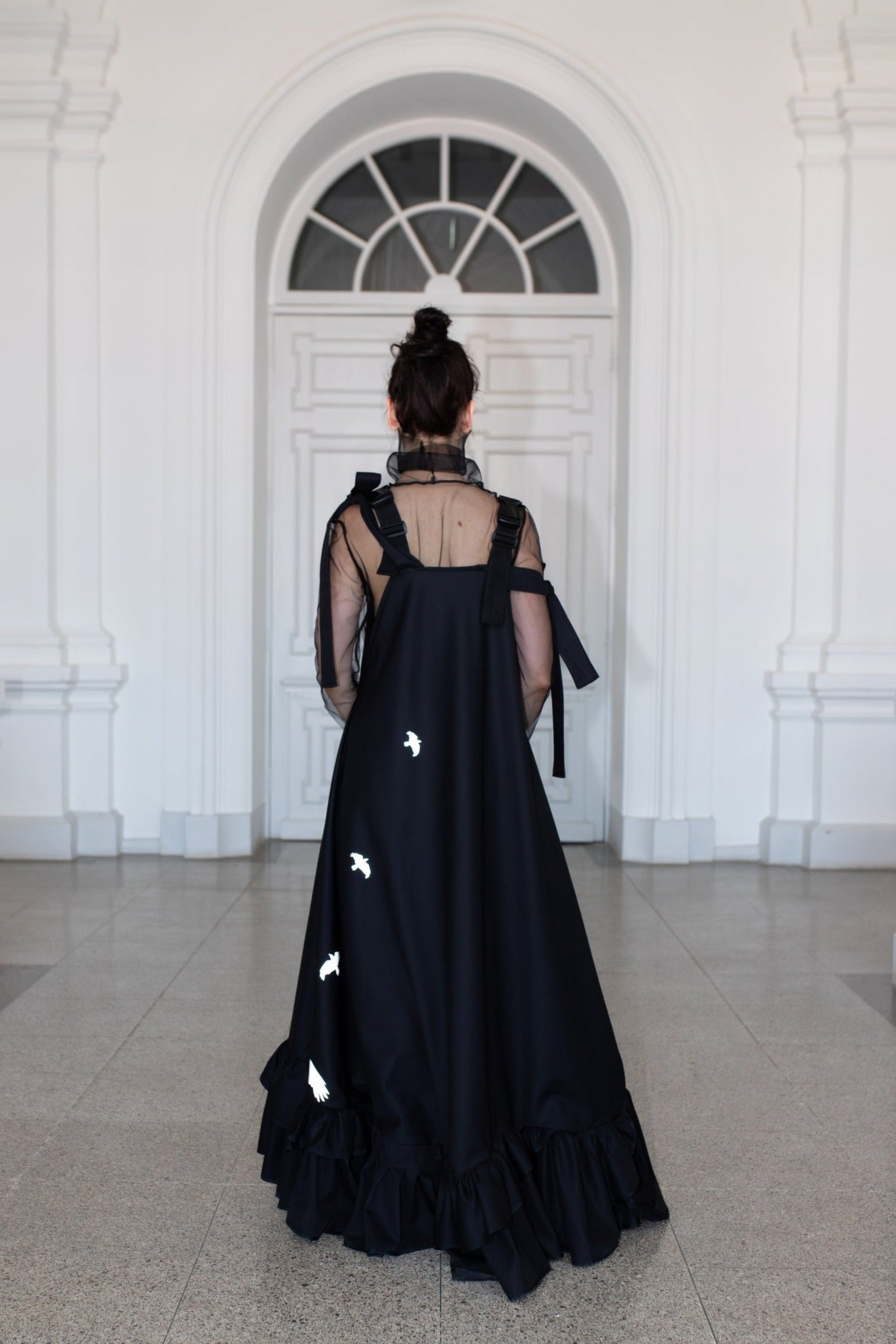 Long, black fronzi dress with reflective birds on the back