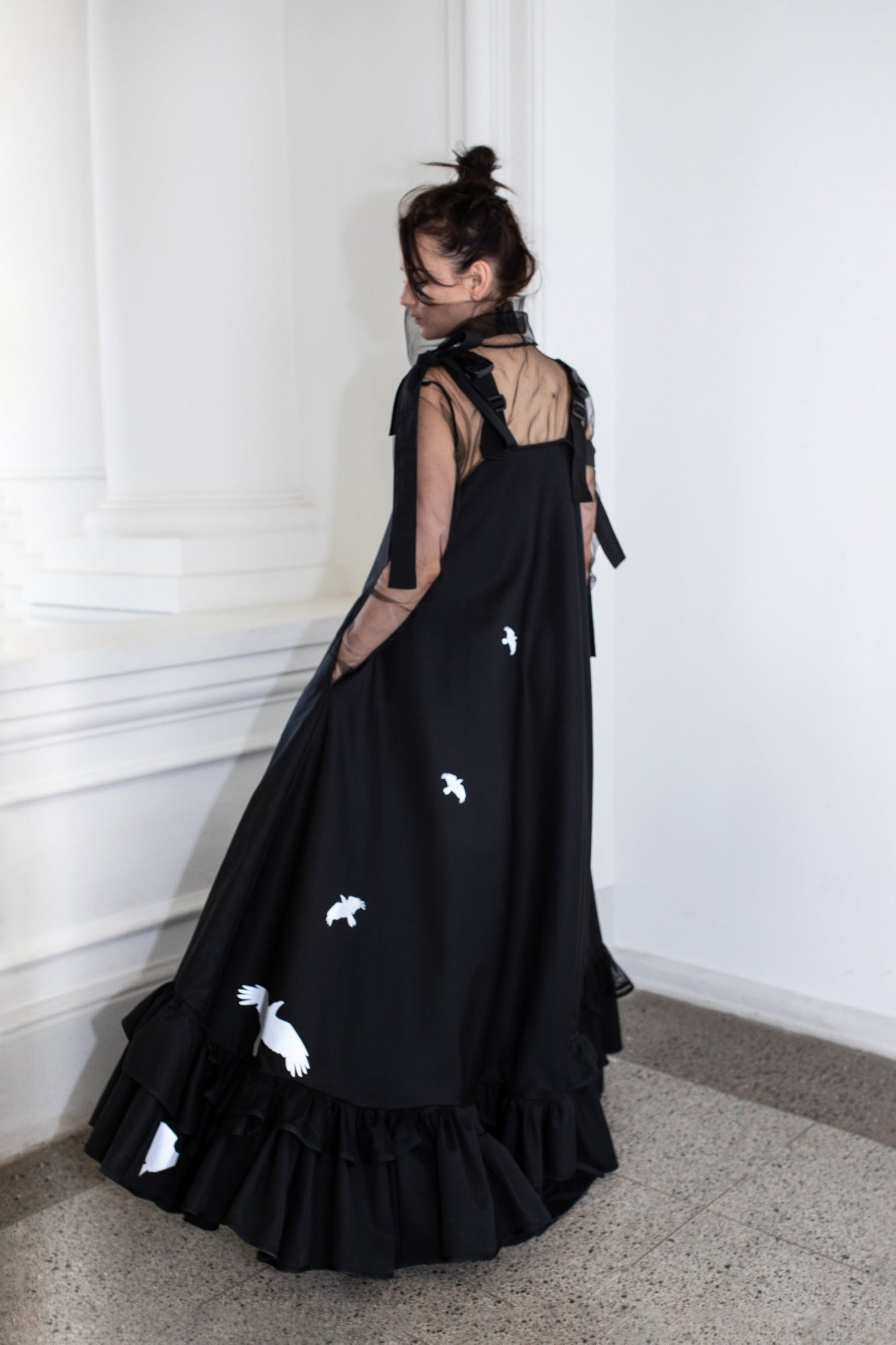 Long, black fronzi dress with reflective birds on the back