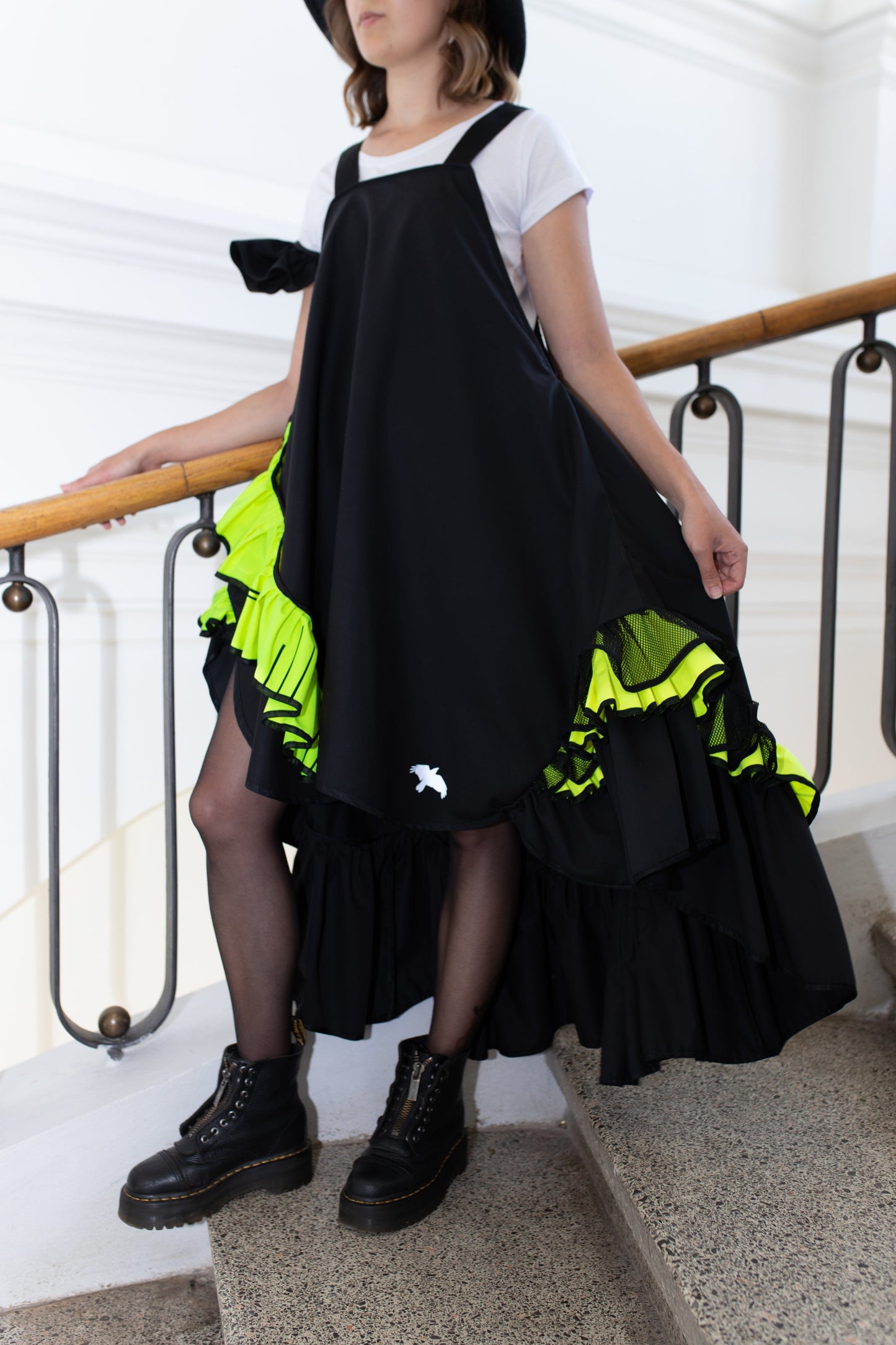 Short, black fronzi dress with neon details and frills