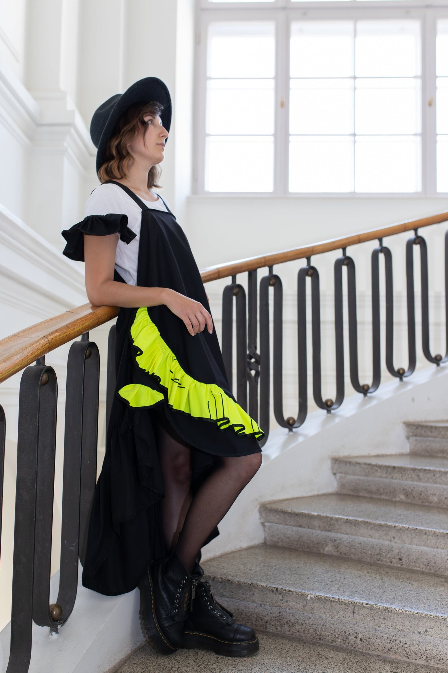 Short, black fronzi dress with neon details and frills