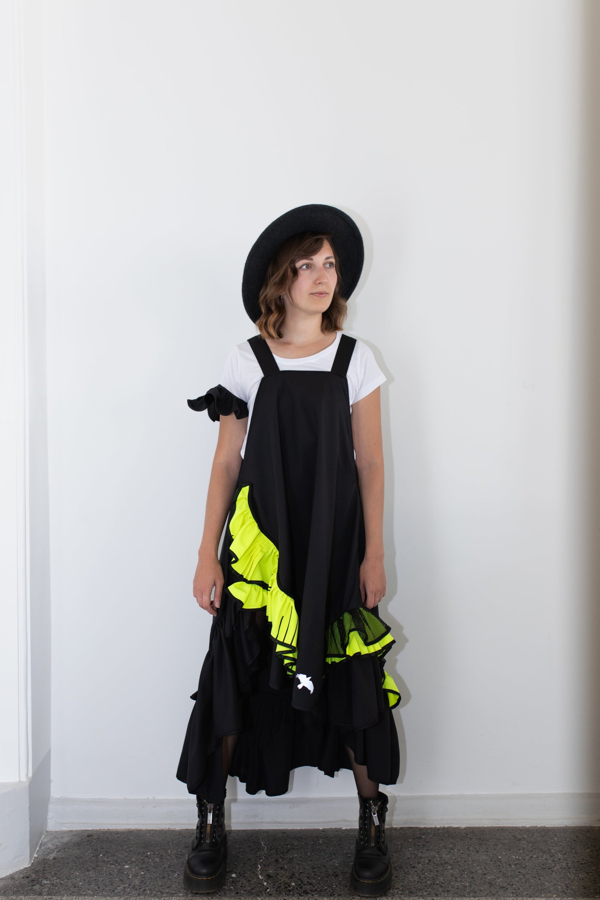 Short, black fronzi dress with neon details and frills