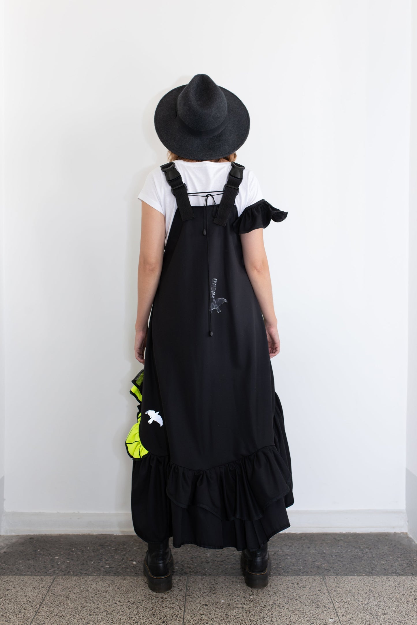 Short, black fronzi dress with neon details and frills