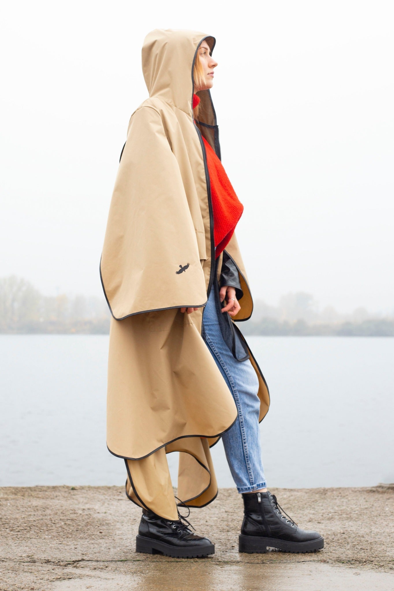 Fronzi raincoat beige with hood, girl standing from side