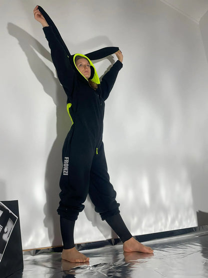 Model wearing a black fleece onesie shot from the side