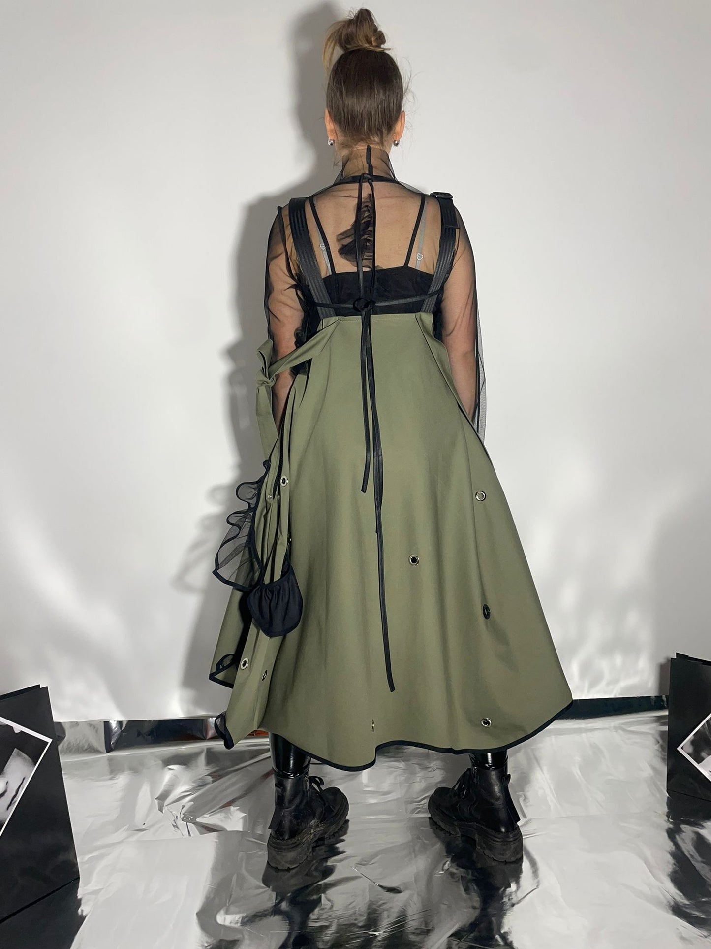 View from the back of a model wearing a khaki color skirt dress