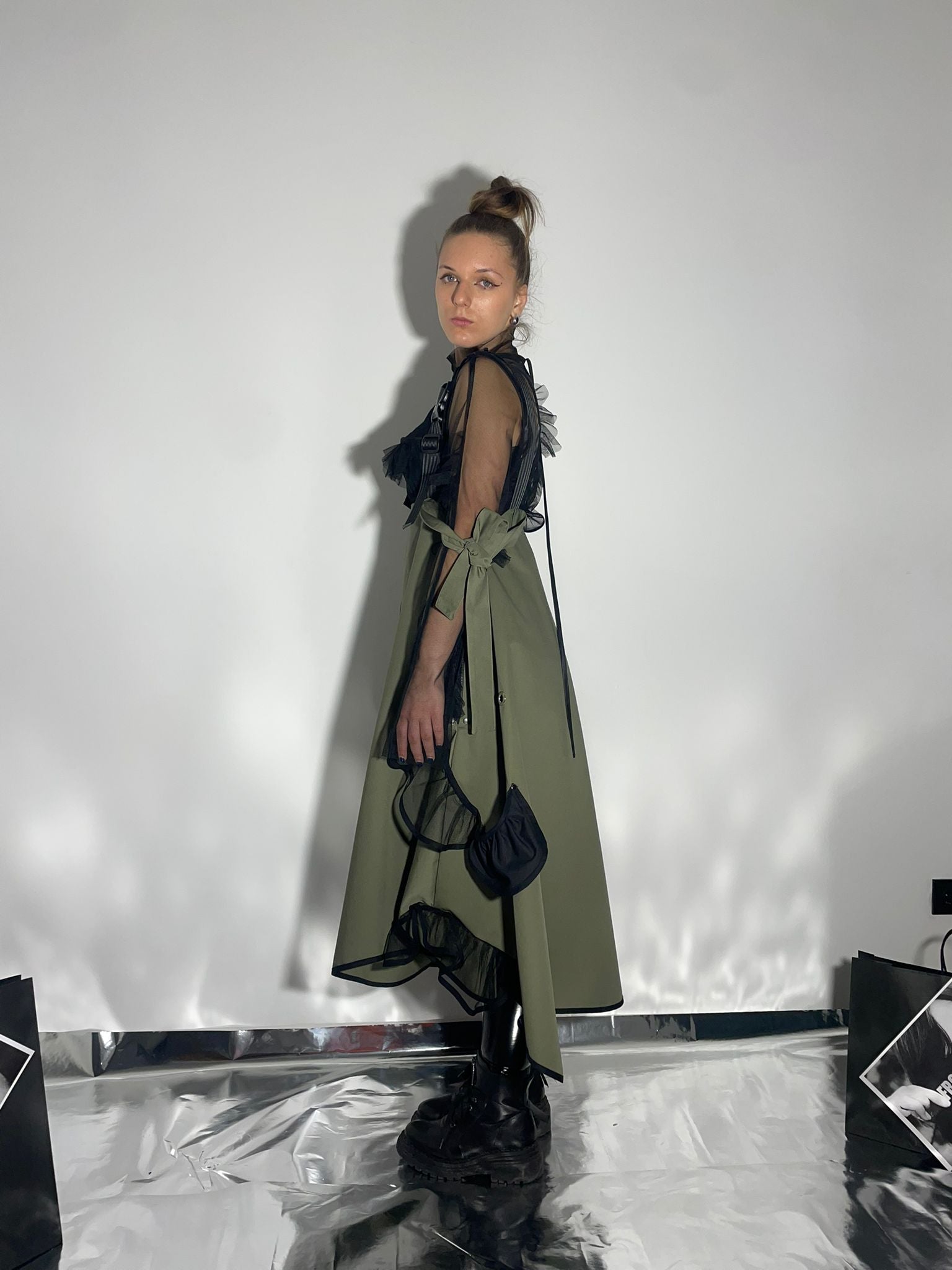 View from the size of model wearing a khaki color dress