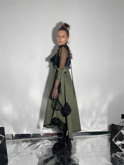 View from the size of model wearing a khaki color dress