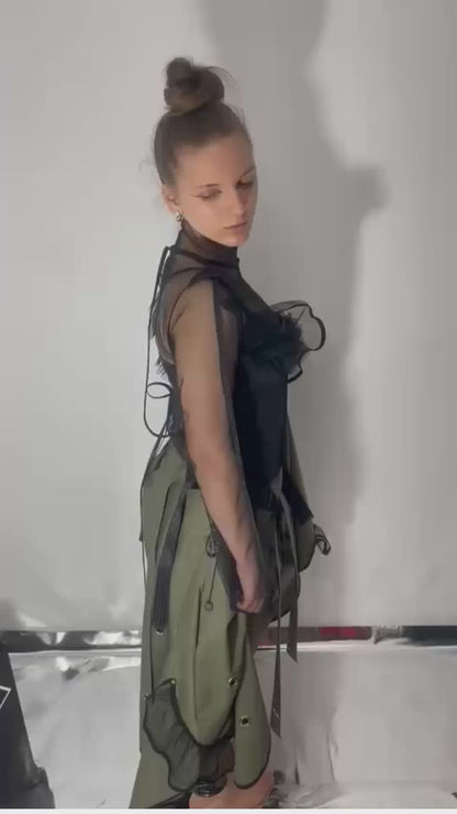 A video of model wearing a khaki color skirt that can transform into a dress, close ups and model walks away